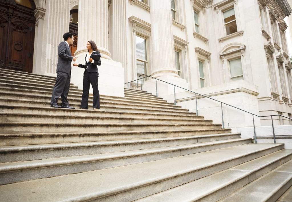Attorney and client on courthouse steps