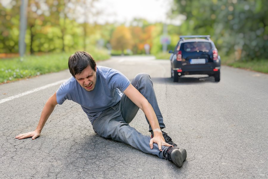 Injured man on road after car hit him and fled