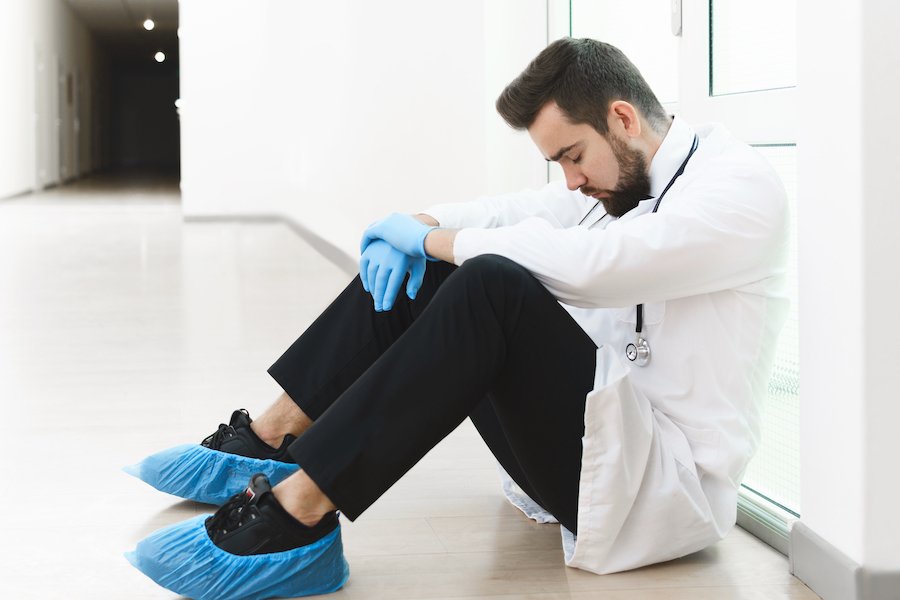Tired hospital staff napping on floor