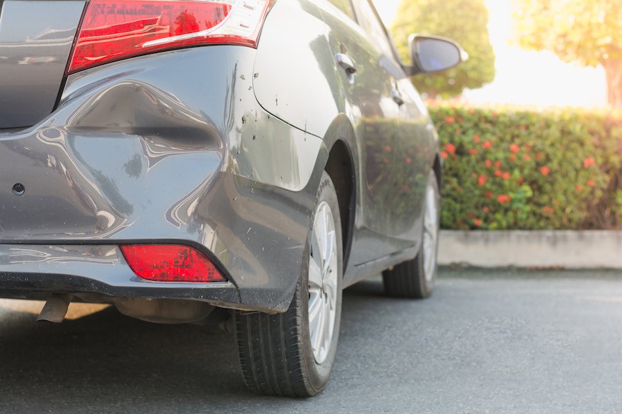Car with dented fender after hit and run