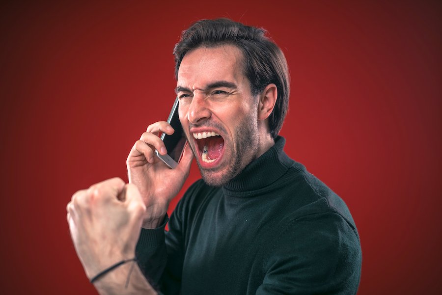 Man screaming into a cell phone