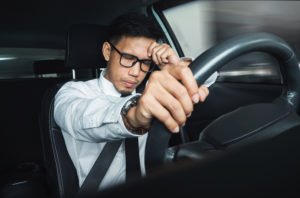 Man sleeping behind the wheel