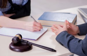 Closeup of worker with attorney discussing case