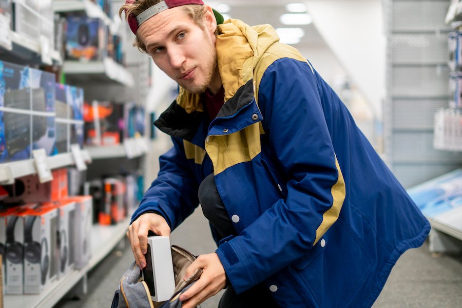 Man stealing iphone from store