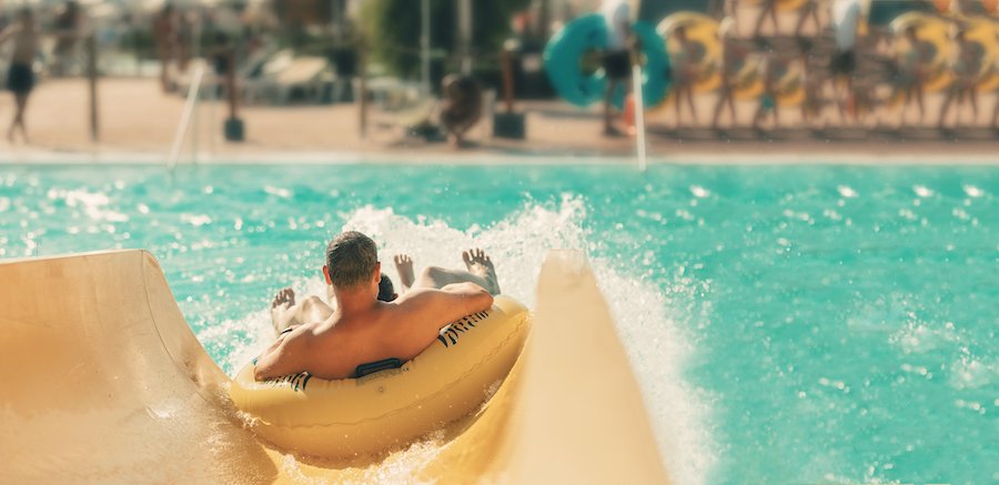 Man in tube going down water slide