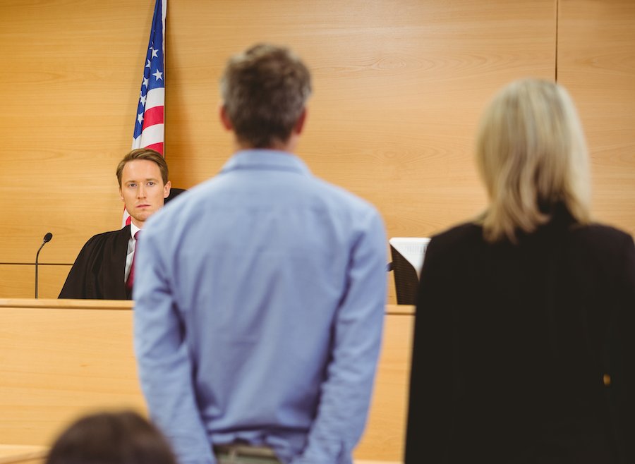 Defendant with attorney being sentenced by judge