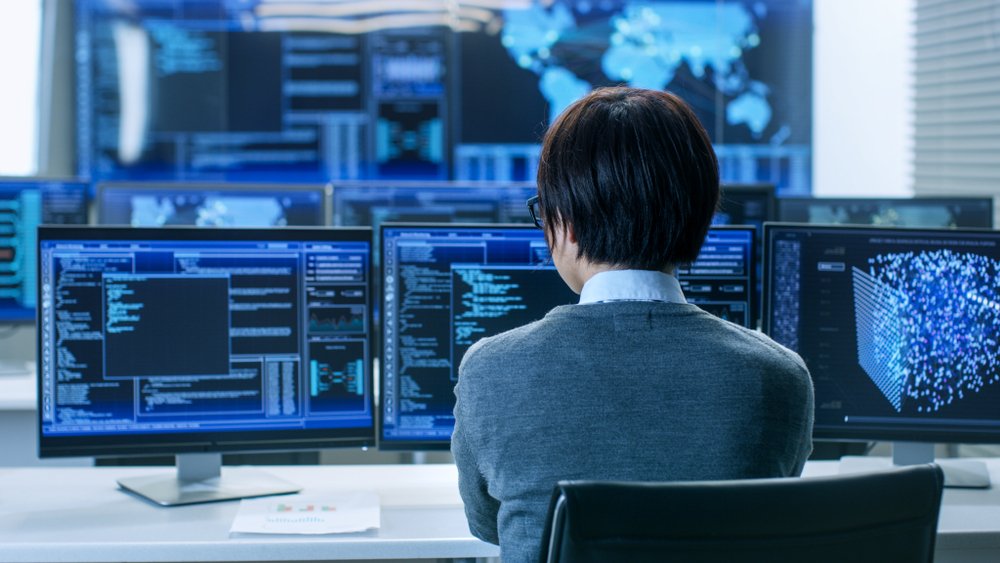 office worker looking at computer screens