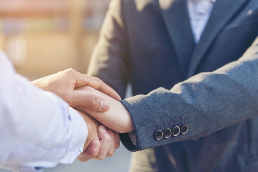 Attorney's hands holding client's hands