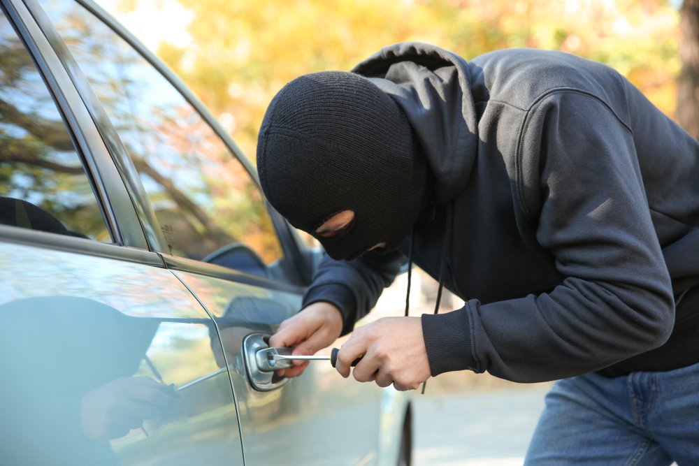 burglar trying to break into car