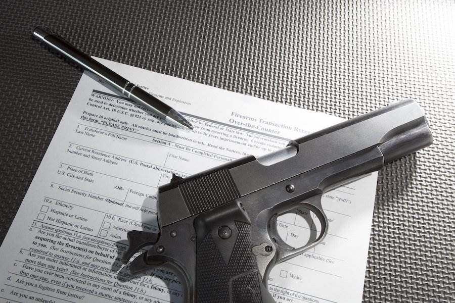 Revolver with pen and background check application