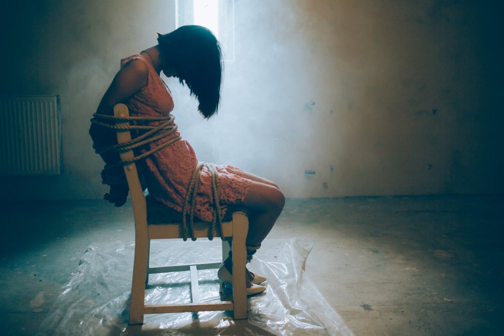 woman tied up to chair