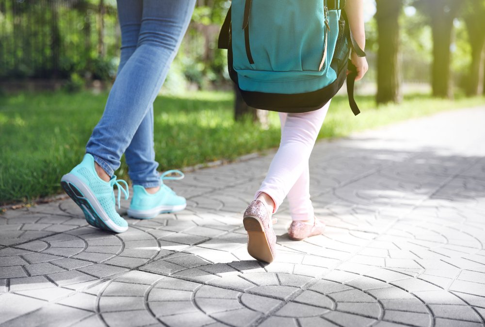 Adult walking with child.