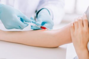 Person having her blood drawn.