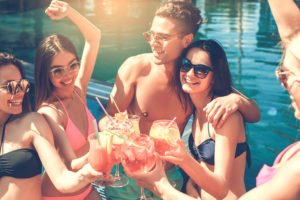 Group of friends together in the swimming pool leisure