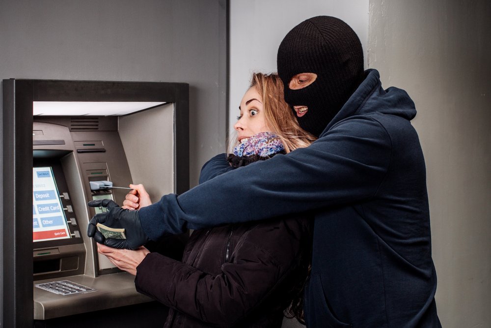 Robber grabbing a girl as she withdraws money from the ATM as an example of first-degree robbery per Penal Code 212.5 PC