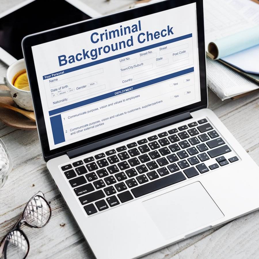 Laptop that says "criminal background check"