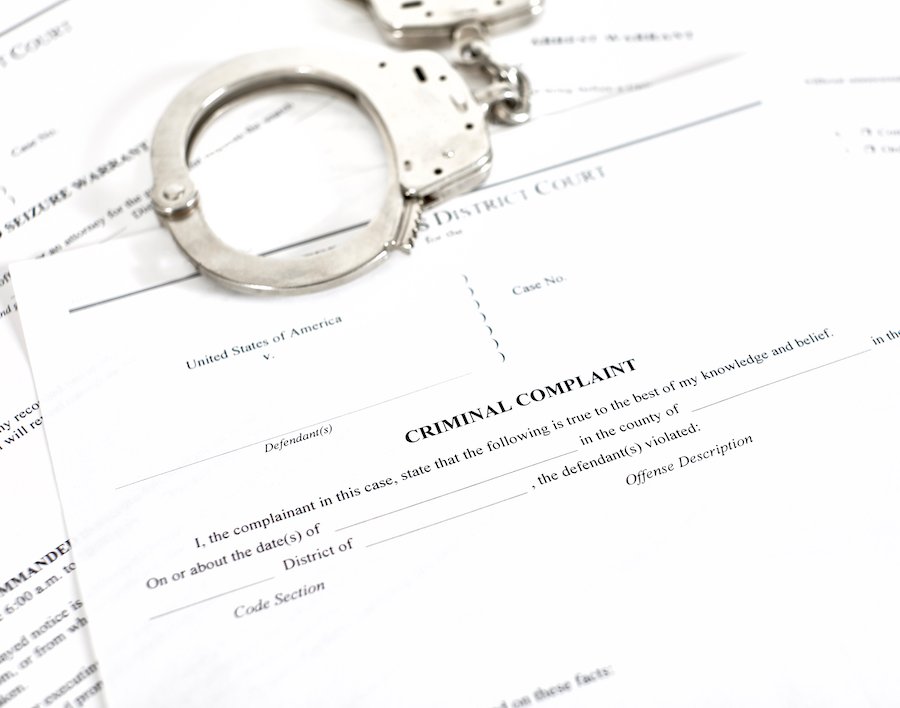 Criminal complaint form with handcuffs
