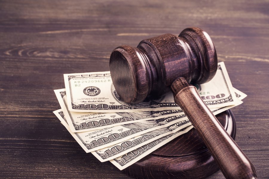 A closeup of a judge's gavel and cash