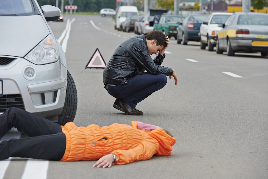 Road accident. Knock down pedestrian and upset driver in front of automobile crash car collision as an example of a Class 4 Felony in Colorado
