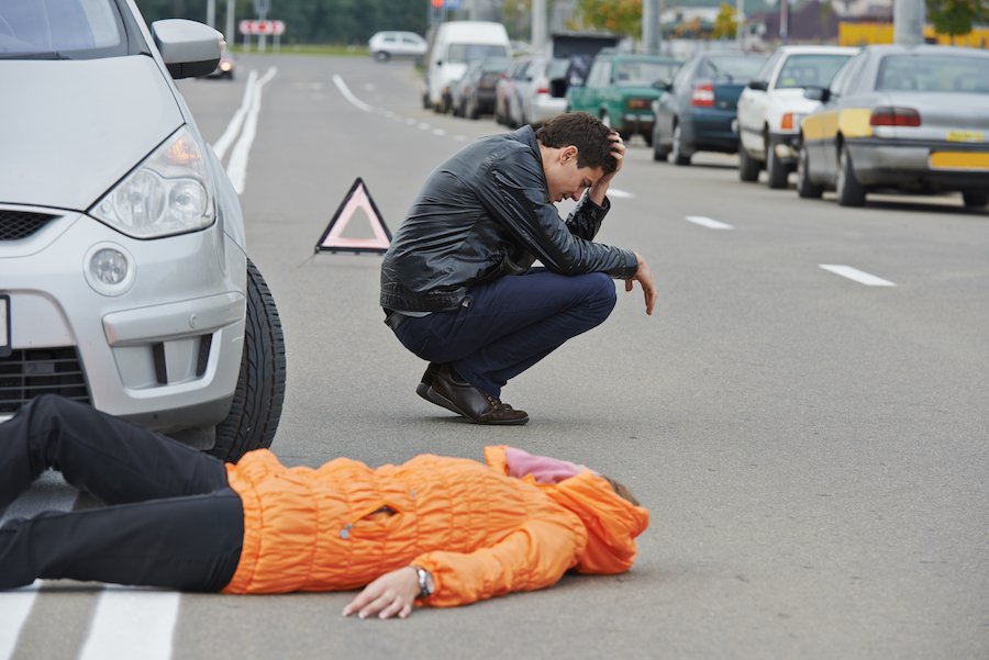 Road accident. Knock down pedestrian and upset driver in front of automobile crash car collision as an example of a Class 4 Felony in Colorado