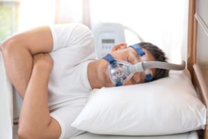 Man sleeping with CPAP machine