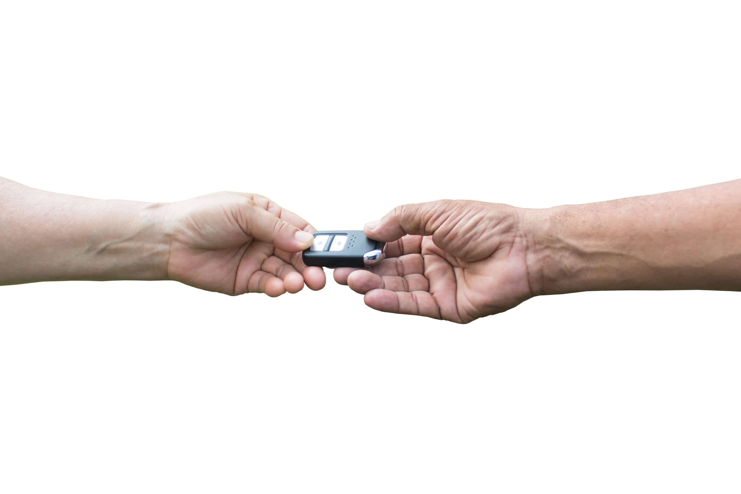 Two hands exchanging a car key fob