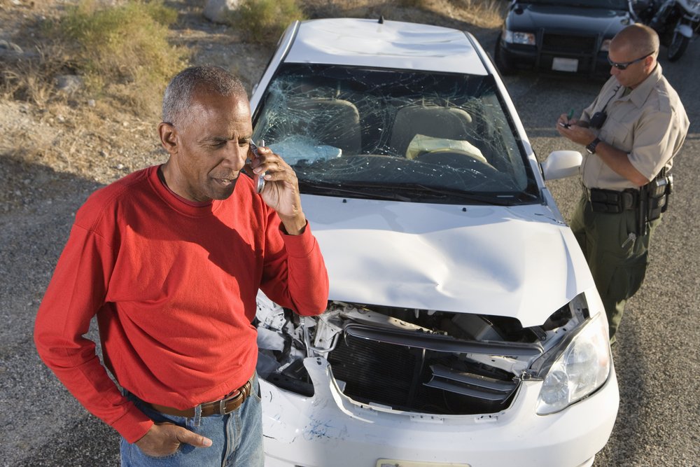 Police officer taking notes at a crash scene