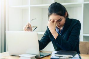 Attorney behind laptop looking upset