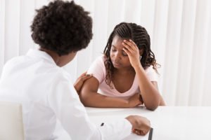 Doctor comforting young patient