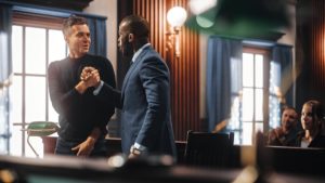 Attorney shaking hands of relieved defendant after successful sentencing hearing