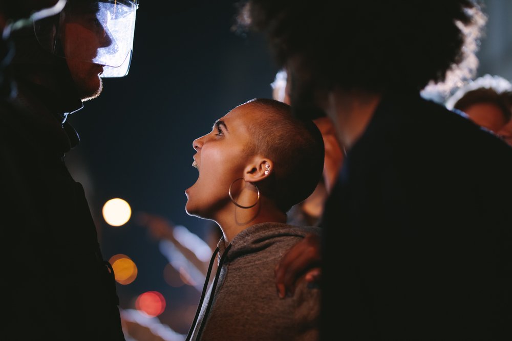 Woman shouting at a police officer.