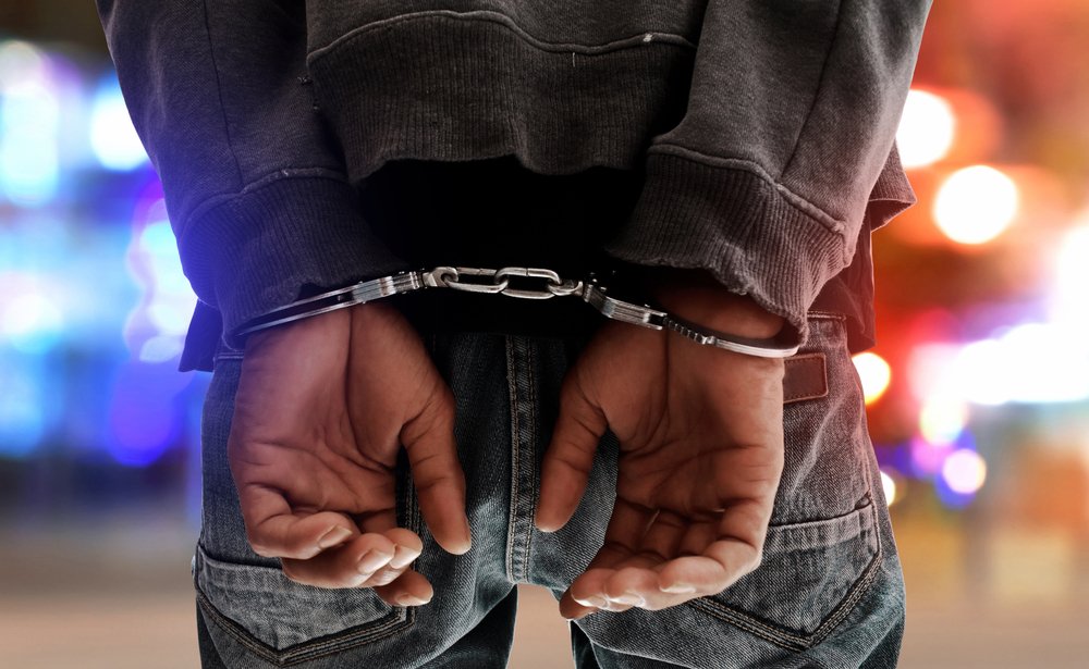 A man in handcuffs after a DUI arrest.