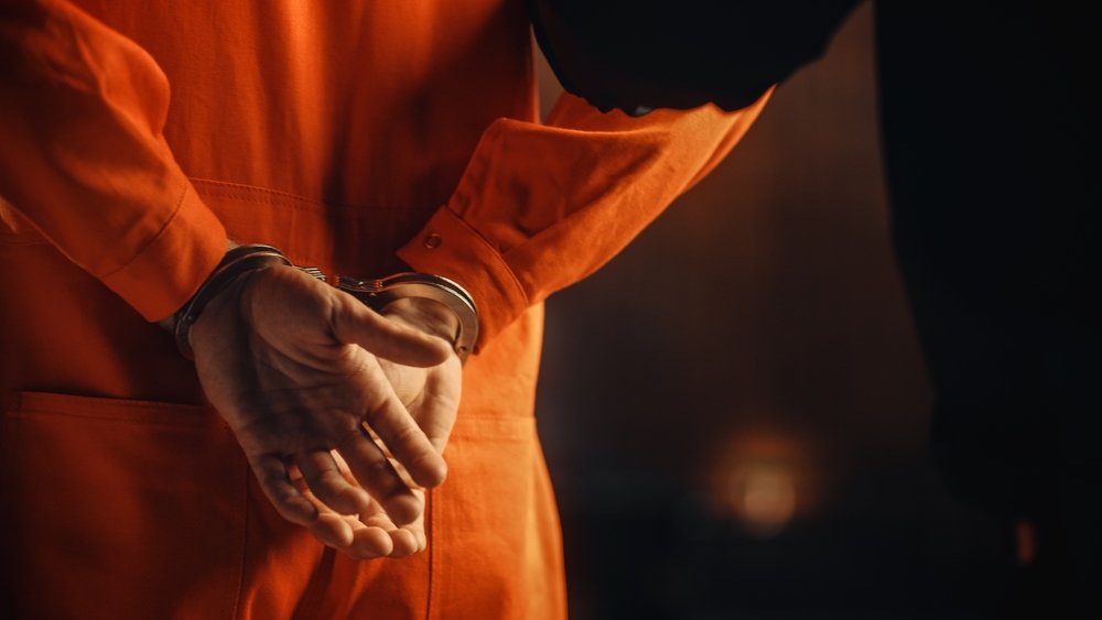 A prisoner wearing an orange jumpsuit.