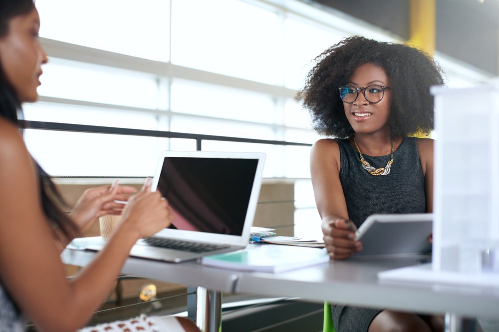 An African American boss and her African American employee.