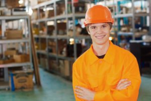 A smiling teen wearing hi-visibility workwear.