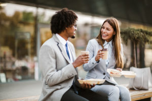 Two office workers enjoying their lunch break together.