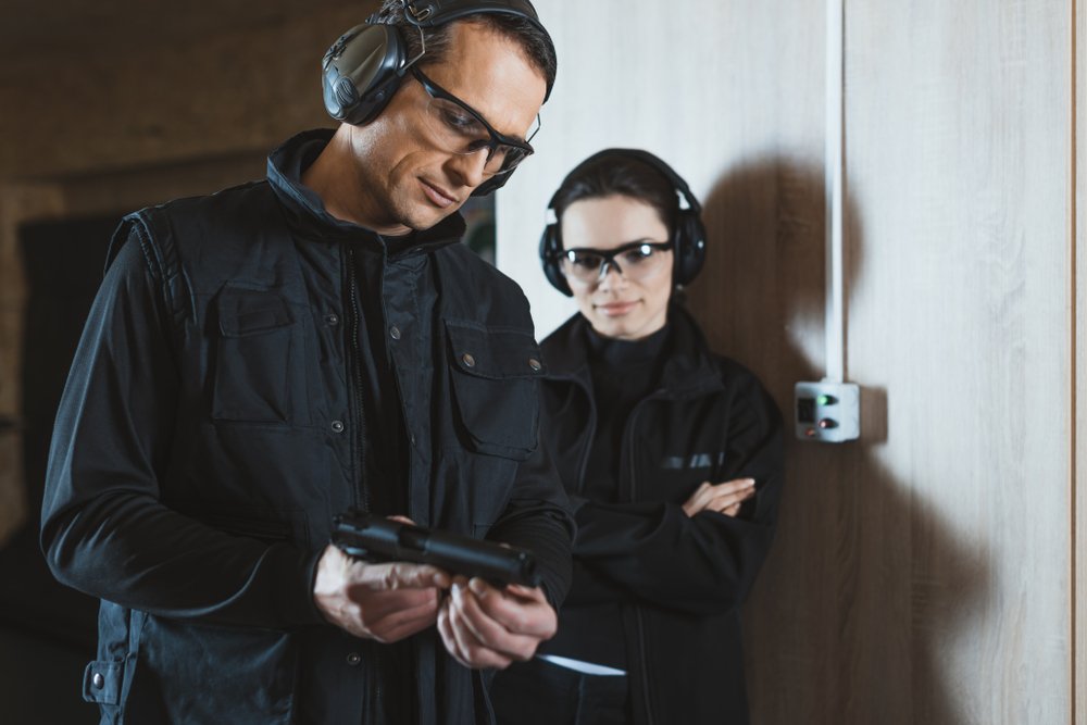 Two people practicing gun safety practices at the range.