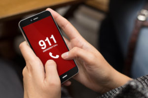 Hand holding phone that says 911