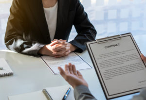 Employer discussing employment contract with new hiree