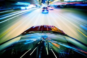 Cars racing on a city street.