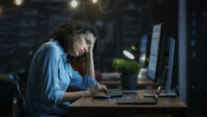 A woman showing signs of tiredness, possibly from working 7 days that week.