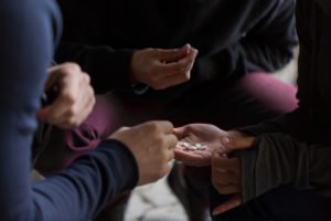 Teens passing around various illicit pills and drugs.