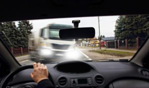 A truck swerving into the lane of oncoming traffic, potentially leading to a truck accident.