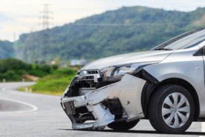 car with dented fender after hit and run