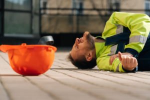 Construction worker on floor with arm injury