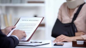 An injured woman speaking with her attorney regarding the negligent acts of the person who caused her injury.