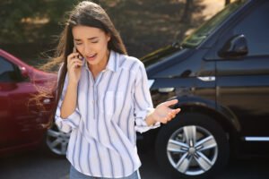 Woman on phone following a fender bender