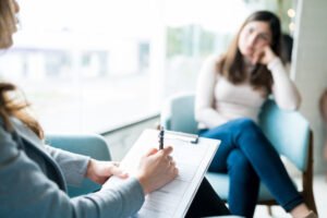 Therapist talking to a counselor with a clipboard