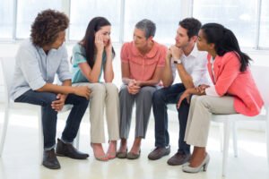 Group counseling session with four patients and one counselor