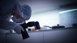 Forensic investigator photographing a crime scene